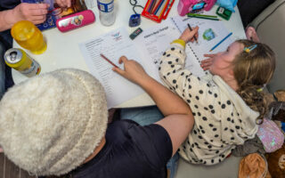 The girls doing homework in the motorhome