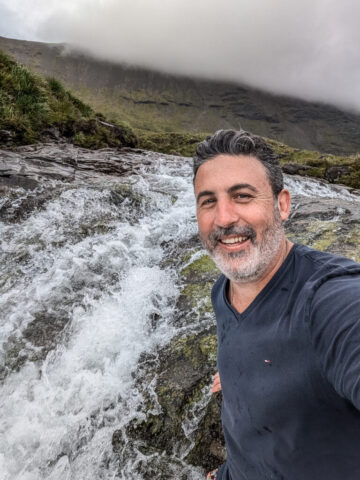 Jumping in and enjoying one of the little waterfalls of the Fairy Pools, Isle of Skye